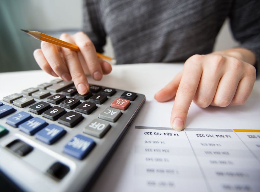 closeup accountant hands counting calculator