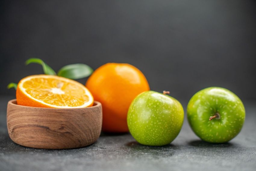 oranges green apple dark table